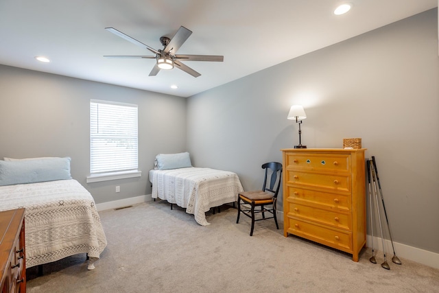 bedroom featuring light carpet, baseboards, and recessed lighting