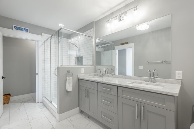 full bathroom featuring marble finish floor, baseboards, a sink, and a stall shower