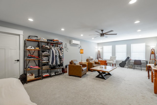 living area with a ceiling fan, recessed lighting, an AC wall unit, and light carpet