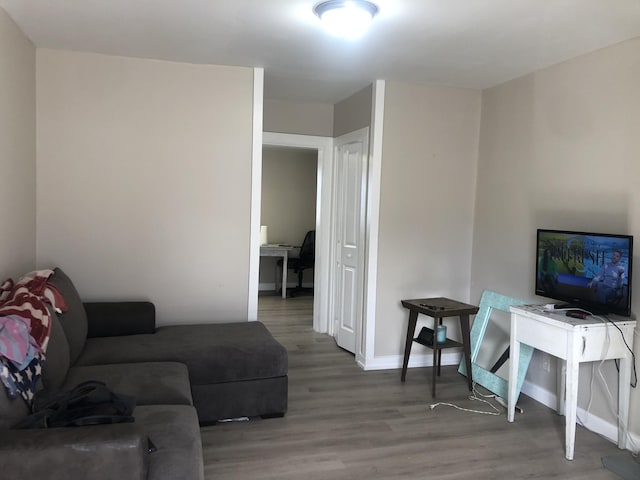 living room with wood finished floors and baseboards