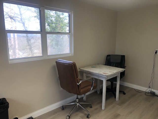 home office featuring light wood-type flooring and baseboards