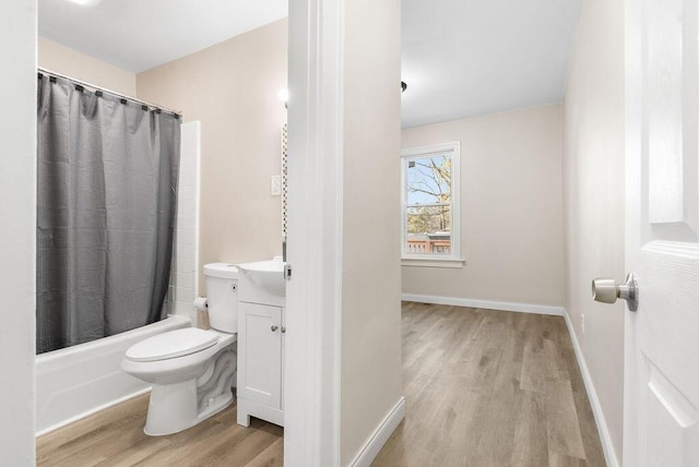 full bathroom with vanity, wood finished floors, baseboards, shower / bath combination with curtain, and toilet