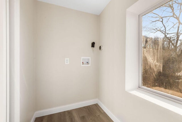 laundry room with laundry area, hookup for a washing machine, wood finished floors, and baseboards