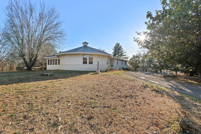 rear view of property featuring a yard