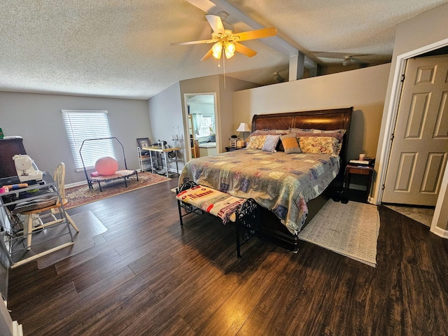 bedroom with dark wood-style floors, vaulted ceiling with beams, a textured ceiling, and ceiling fan