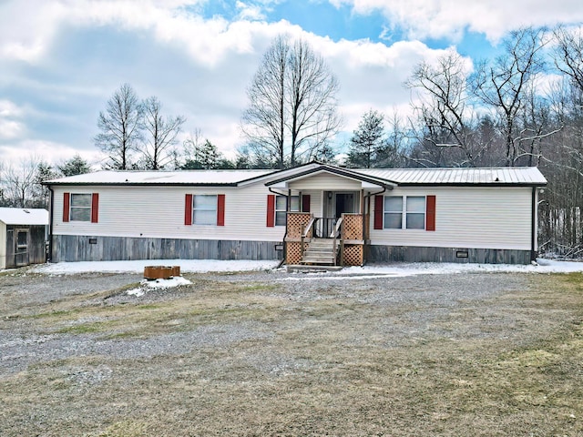 manufactured / mobile home featuring a porch and metal roof