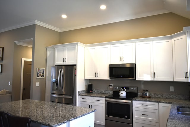 kitchen featuring stainless steel appliances, ornamental molding, and white cabinetry