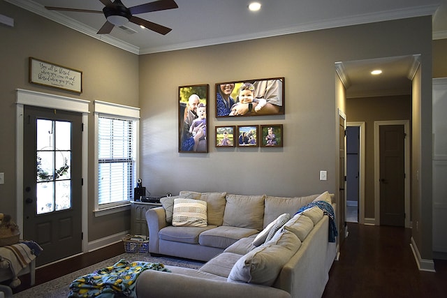 living room featuring ceiling fan, visible vents, baseboards, dark wood finished floors, and crown molding