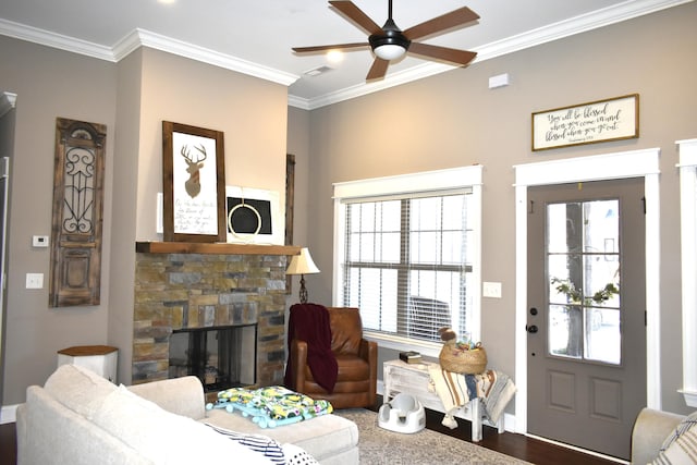 living room with a wealth of natural light, a fireplace, and crown molding