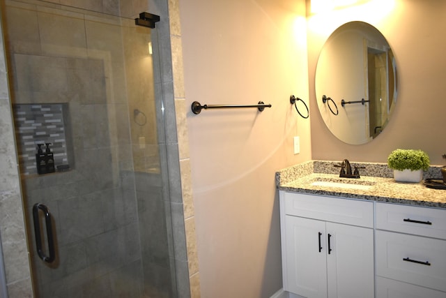 full bathroom with a shower stall and vanity