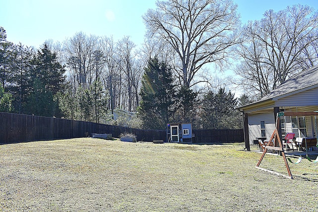 view of yard with an outdoor structure and a fenced backyard