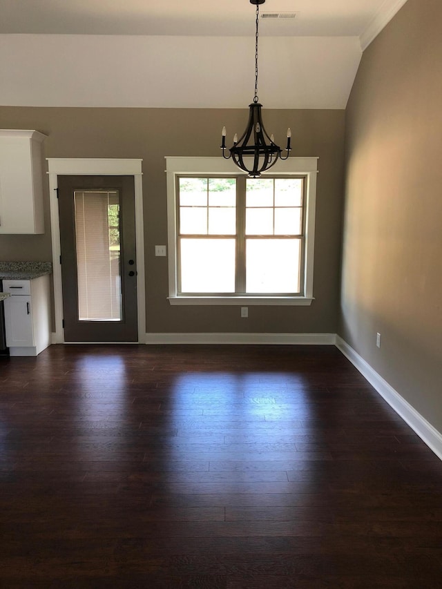 unfurnished dining area featuring visible vents, baseboards, lofted ceiling, dark wood-style floors, and a notable chandelier