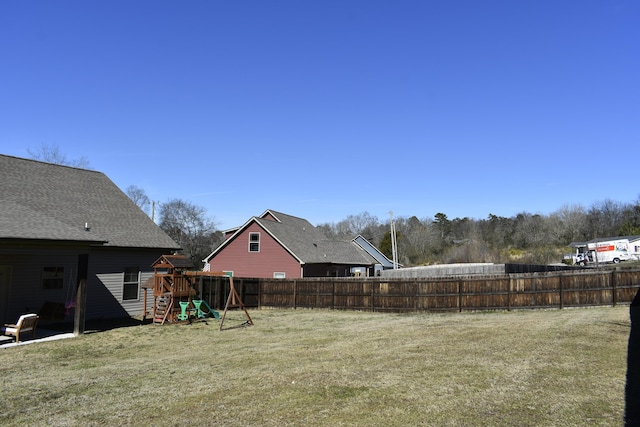 view of yard with a playground and a fenced backyard