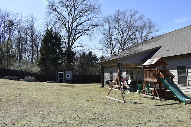 view of yard featuring a playground and fence