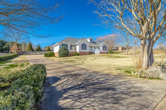 view of front of home featuring a front lawn, crawl space, and fence