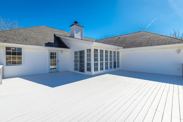 wooden deck with a sunroom