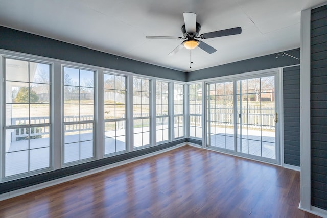 unfurnished sunroom with a ceiling fan