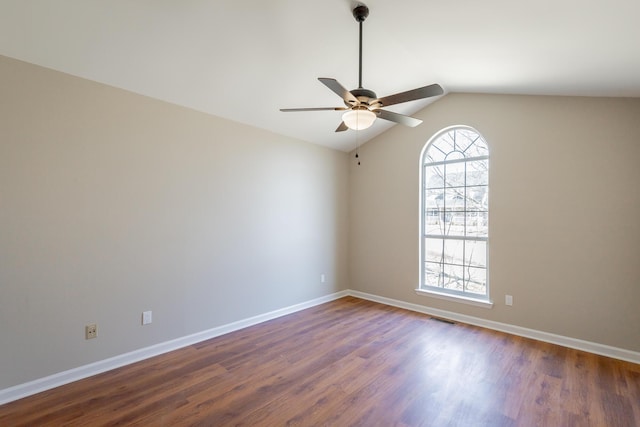 unfurnished room featuring vaulted ceiling, visible vents, dark wood finished floors, and baseboards