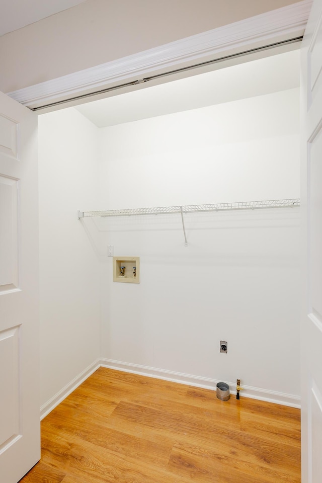 laundry room with light wood-style flooring, laundry area, washer hookup, baseboards, and electric dryer hookup