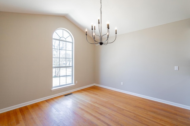 unfurnished room with a healthy amount of sunlight, visible vents, baseboards, and light wood finished floors