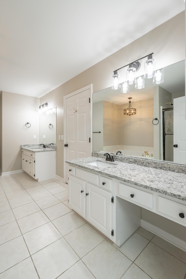 bathroom with two vanities, a sink, a shower stall, tile patterned flooring, and baseboards