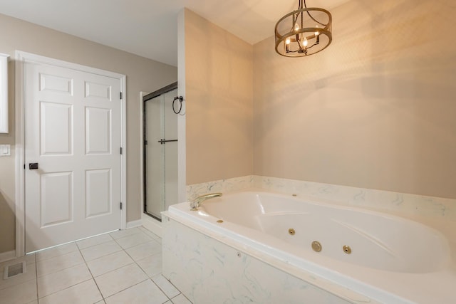 full bath featuring a stall shower, tile patterned flooring, a chandelier, and a whirlpool tub