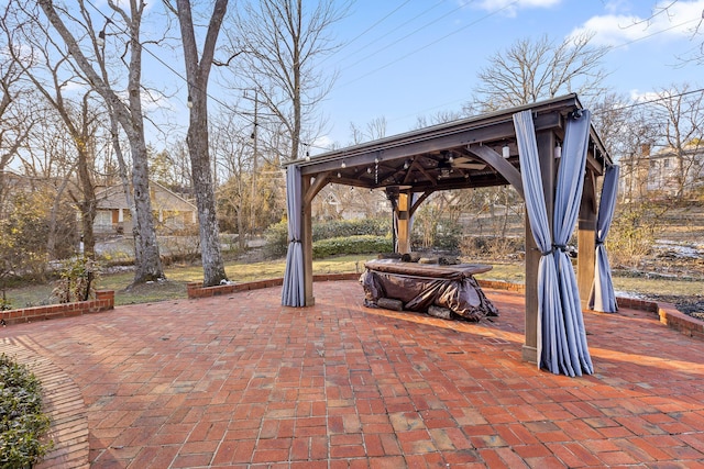 view of patio / terrace with a ceiling fan and a gazebo