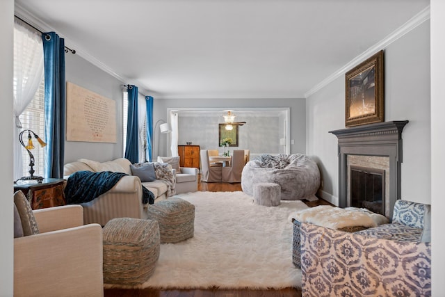 living room with a premium fireplace, wood finished floors, and crown molding