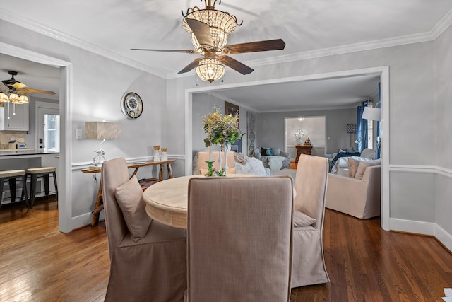 dining room featuring ornamental molding, a wealth of natural light, and wood finished floors