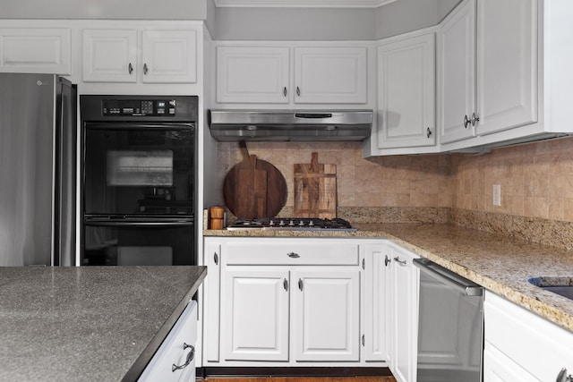 kitchen with stainless steel appliances, tasteful backsplash, white cabinets, and under cabinet range hood