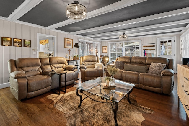 living area with beam ceiling, a chandelier, and wood finished floors