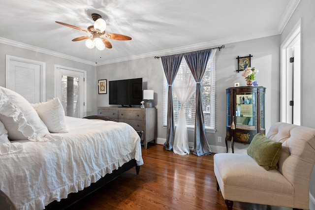 bedroom featuring a ceiling fan, crown molding, baseboards, and wood finished floors