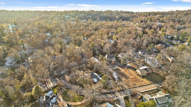 birds eye view of property featuring a wooded view