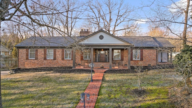 bungalow featuring a porch, a chimney, a front lawn, and brick siding