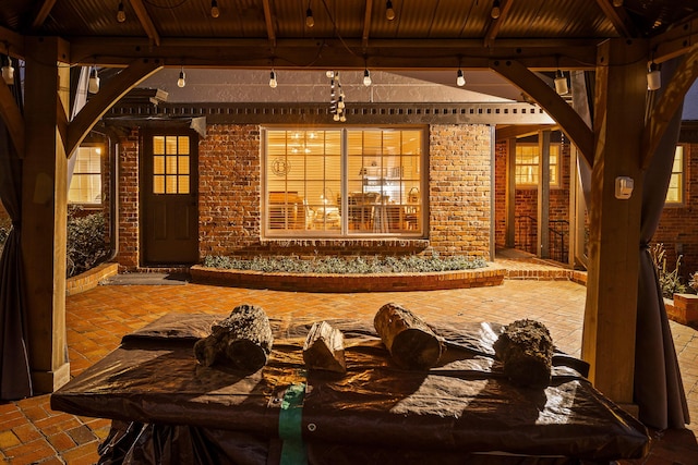 wine area featuring brick floor, wooden ceiling, brick wall, and beam ceiling