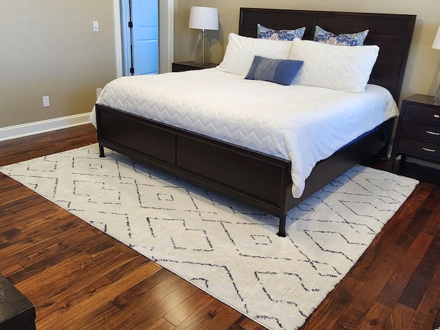 bedroom featuring wood finished floors and baseboards