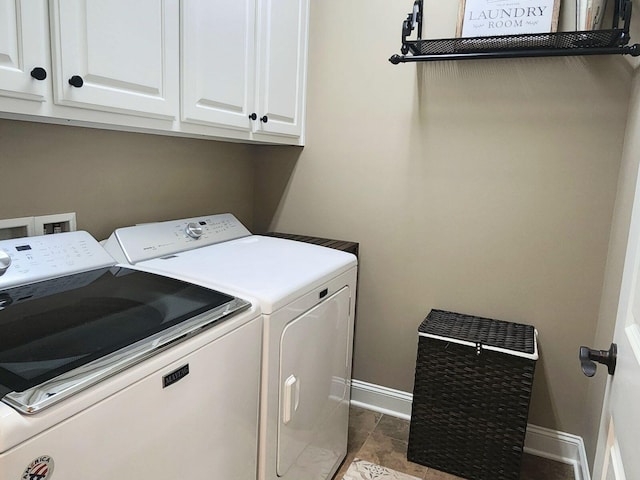 laundry room featuring cabinet space, baseboards, and separate washer and dryer