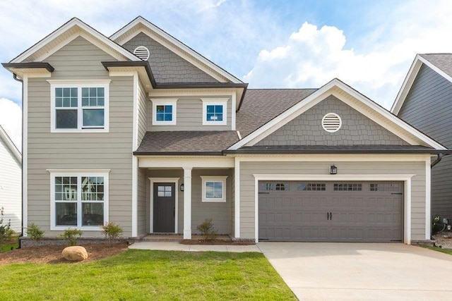 view of front of property with a front lawn, concrete driveway, a shingled roof, and an attached garage