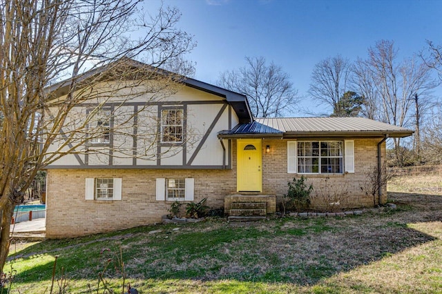 tri-level home with brick siding and metal roof