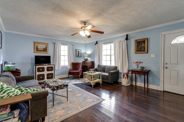 living room with dark wood-style floors, a healthy amount of sunlight, and ornamental molding