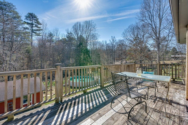 wooden terrace featuring outdoor dining space