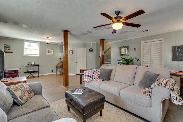 living room with baseboards, visible vents, ornamental molding, stairs, and a textured ceiling