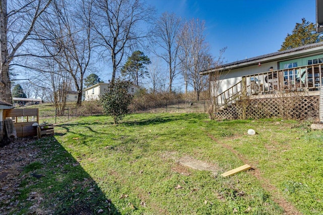 view of yard featuring fence, stairway, and a wooden deck