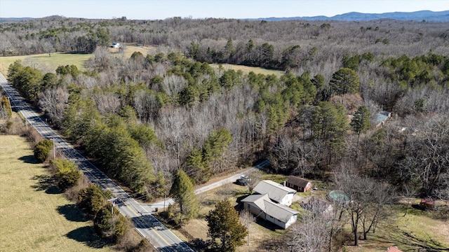 birds eye view of property featuring a mountain view and a view of trees