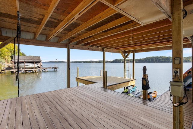 dock area with a water view and boat lift