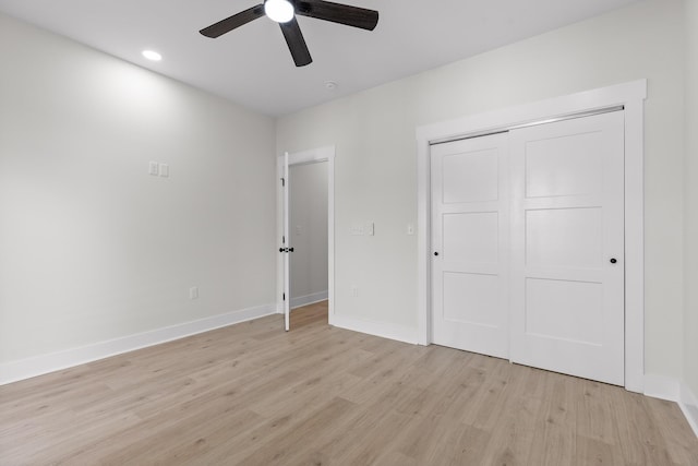 unfurnished bedroom with baseboards, a ceiling fan, light wood-type flooring, a closet, and recessed lighting