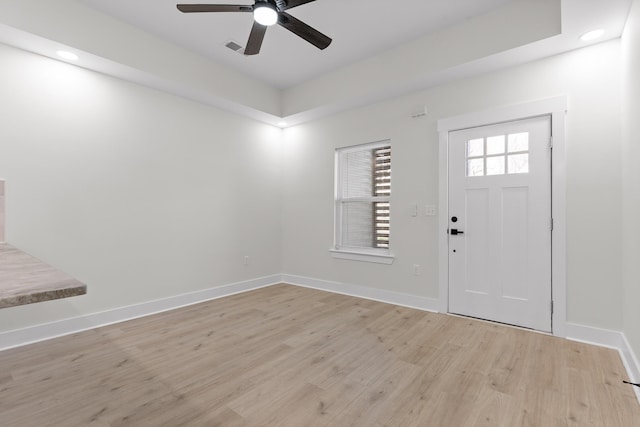 foyer featuring light wood-type flooring, ceiling fan, and baseboards