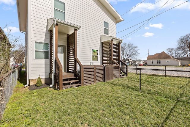 exterior space featuring a fenced backyard, a yard, and a deck