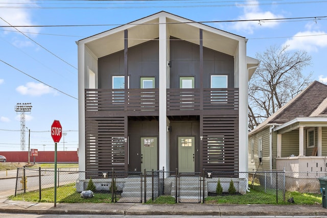 view of front of home with a fenced front yard and a gate