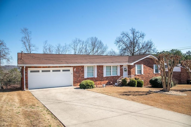 single story home featuring a garage, brick siding, and driveway